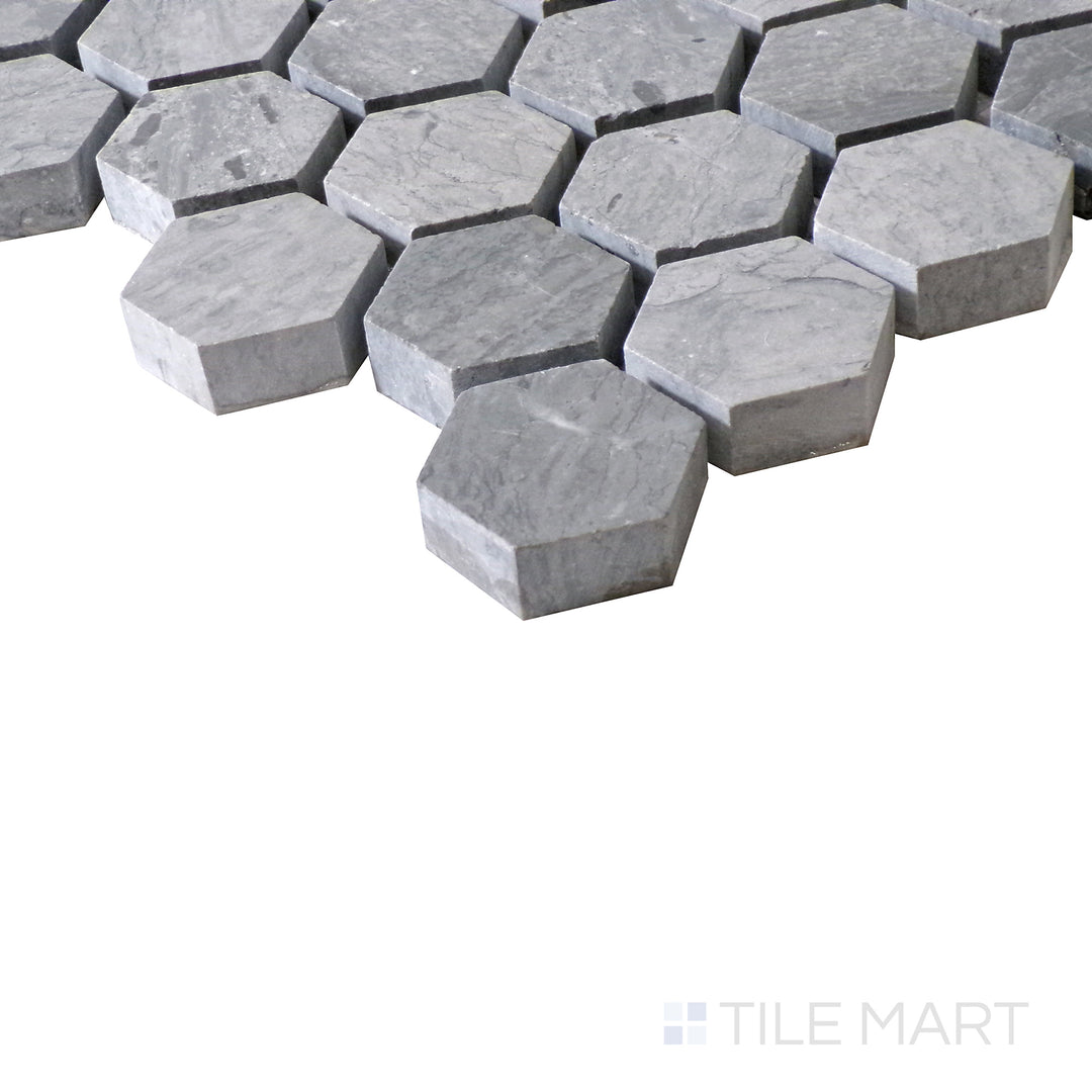 Slanted perspective of Sto-Re Wooden Blue 1-1/8" Hexagon polished marble mosaic, highlighting its unique blue-gray hues, geometric hexagonal shapes, and polished surface.  