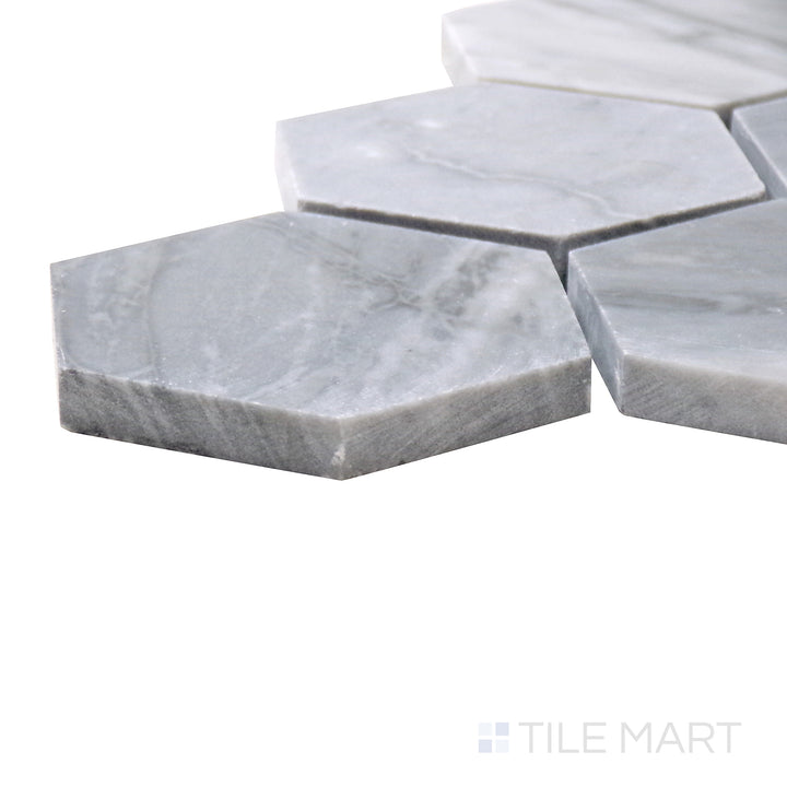 Corner-focused shot of Sto-Re Bardiglio 2-1/2" Hexagon Polished Marble Mosaic, showcasing its deep gray tones in a large hexagonal pattern.