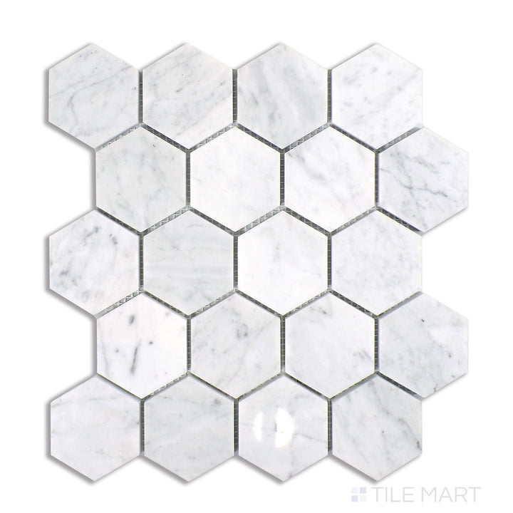 Flat lay of Sto-Re Carrara 2-1/2" Hexagon Polished Marble Mosaic, featuring luxurious white Carrara marble in a bold, large-scale hexagonal layout with a polished surface.