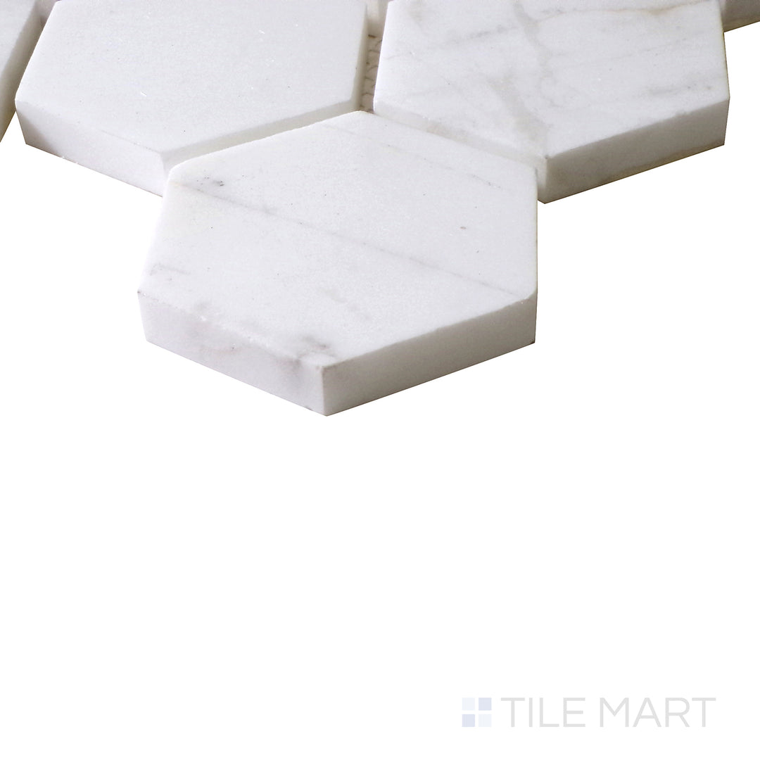 Angled view of Sto-Re Volakas 2-1/2" Hexagon polished marble mosaic, featuring its delicate veining, high-gloss finish, and structured hexagonal design.  