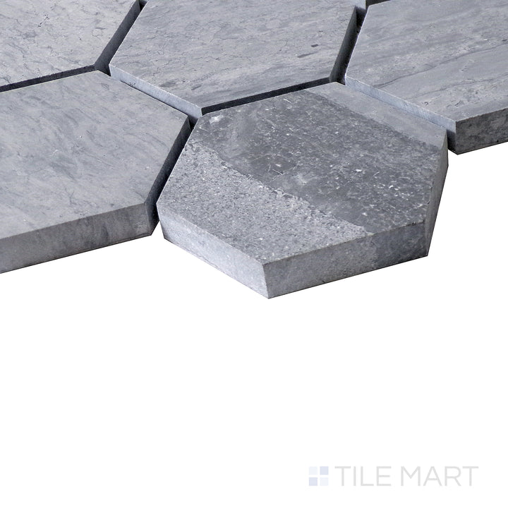 Diagonal shot of Sto-Re Wooden Blue 2-1/2" Hexagon polished marble mosaic, emphasizing its soft blue-gray color, larger hexagonal tiles, and polished aesthetic.  