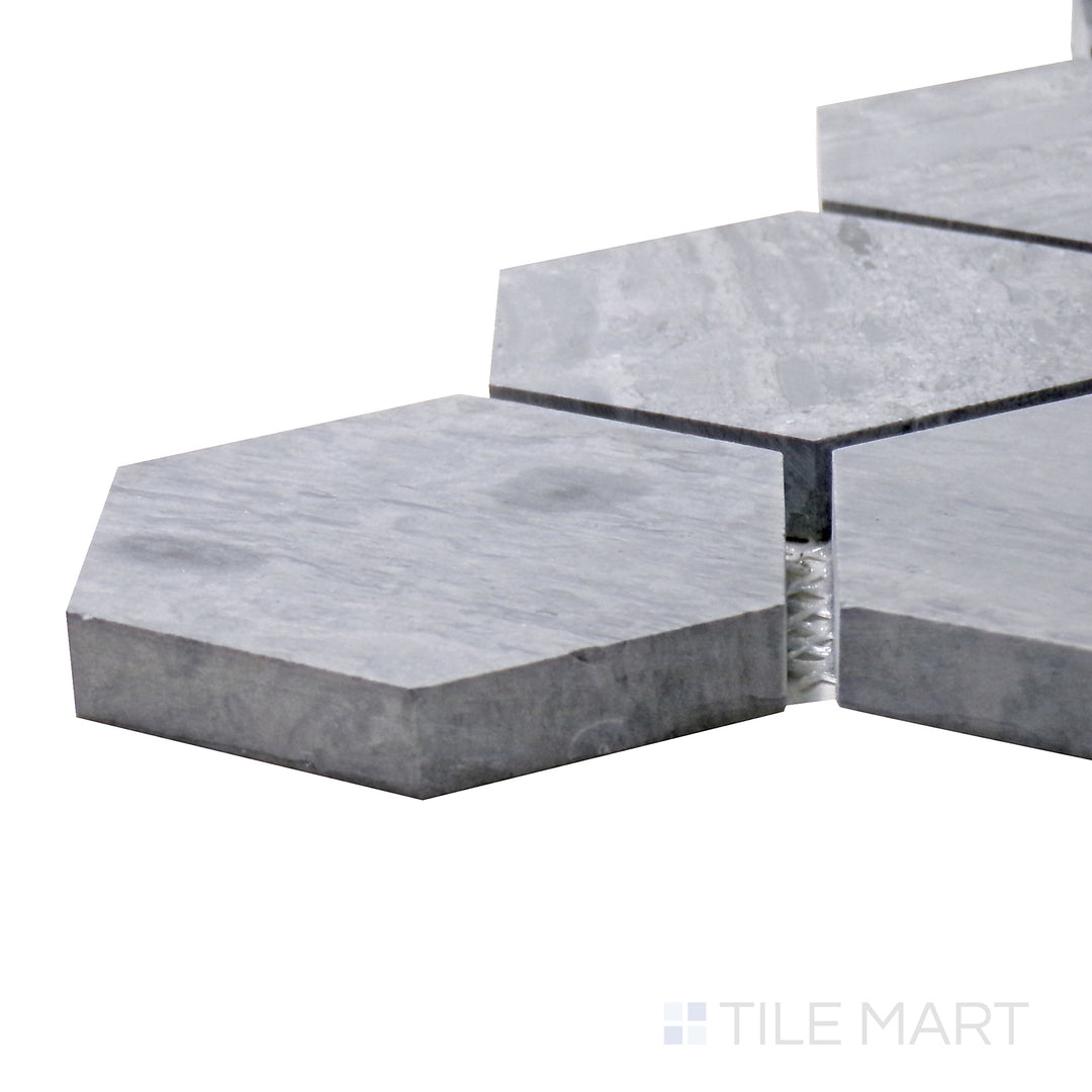Side angle of Sto-Re Wooden Blue 2-1/2" Hexagon Polished Marble Mosaic, showcasing its cool blue-gray hues with a polished hexagonal pattern.
