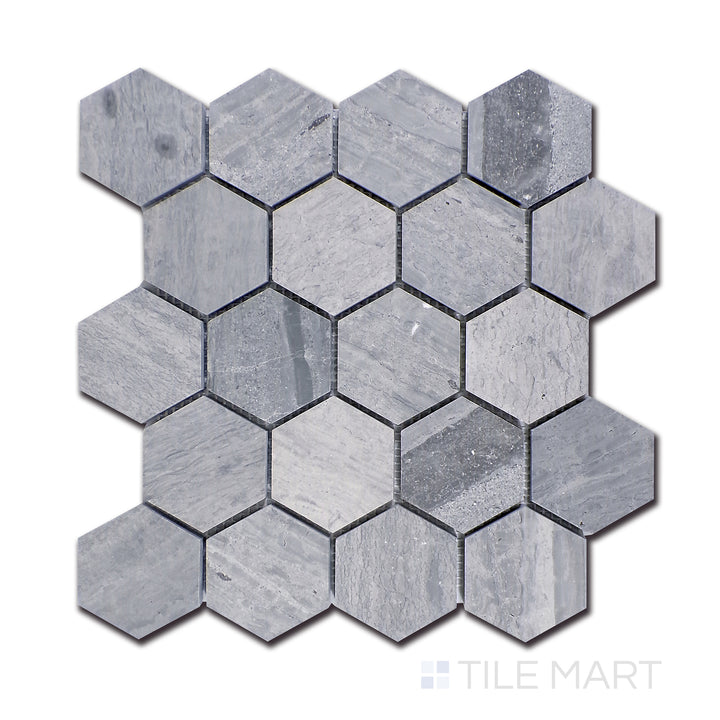 An overhead perspective of Wooden Blue marble, crafted into 2.5-inch hexagonal pieces, showcasing deep blue-gray streaks against a neutral base for a striking visual appeal.