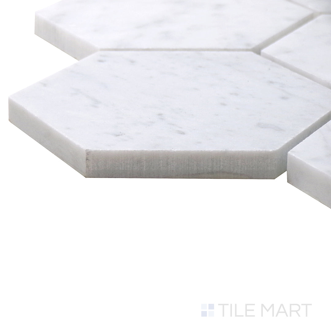 Angled view of Sto-Re Carrara 4" Hexagon Polished Marble Mosaic, displaying its refined white marble with light gray veining in a geometric pattern.