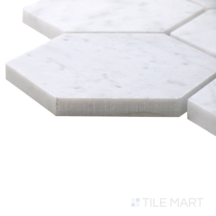 Angled view of Sto-Re Carrara 4" Hexagon Polished Marble Mosaic, displaying its refined white marble with light gray veining in a geometric pattern.