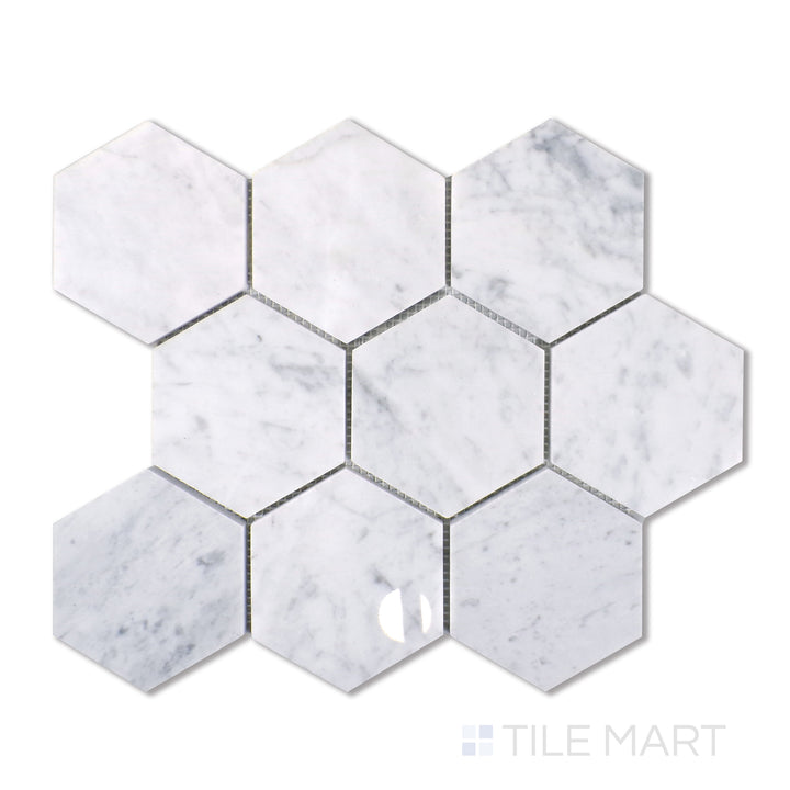 An aerial shot capturing the elegance of Carrara marble in a spacious 4-inch hexagon arrangement, displaying a luminous white background with wispy gray movement and a polished finish.