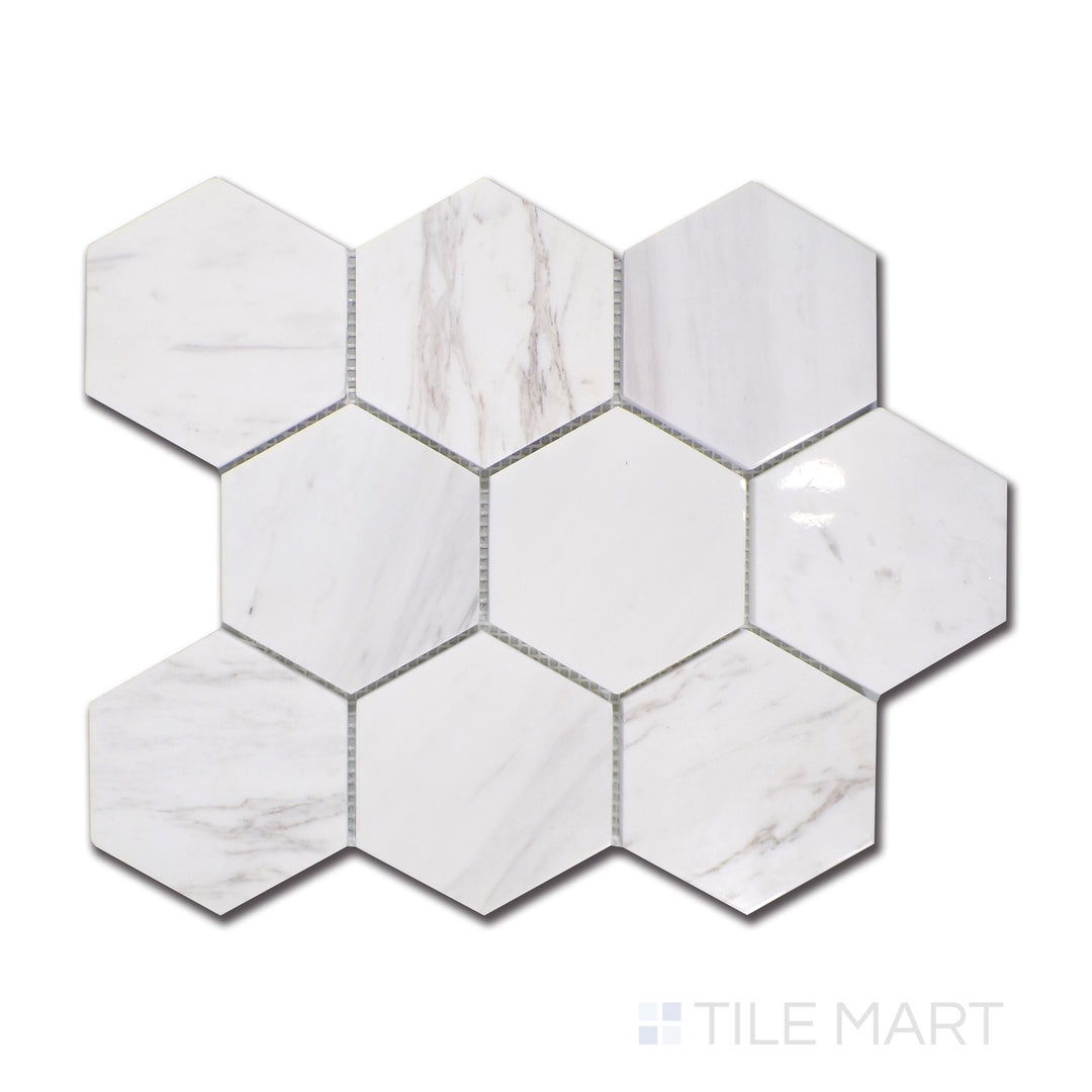 An overhead look at Volakas marble arranged in a bold 4-inch hexagon structure, harmonizing classic white surfaces with fluid, smoky gray veining, enhanced by a polished touch.