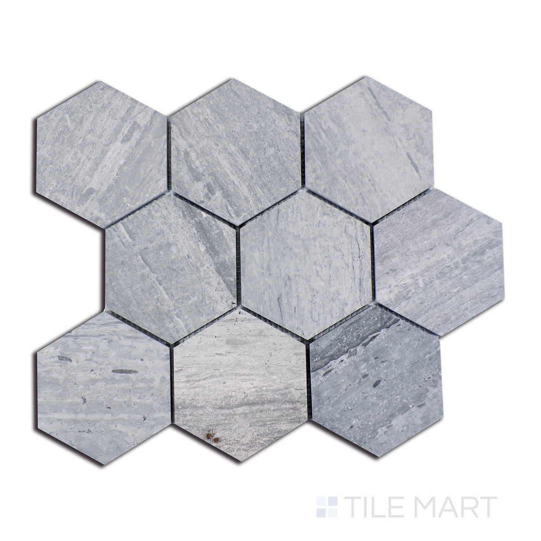 A high-angle perspective highlighting Wooden Blue marble tiles in an expansive 4-inch hexagonal configuration, blending rich blue undertones with subtle earthy textures and a high-gloss finish.