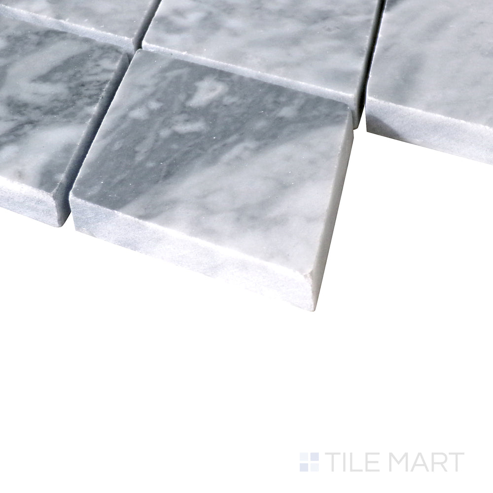 Slanted shot of Sto-Re Bardiglio Rhomboid polished marble mosaic, featuring deep gray hues, a striking rhomboid arrangement, and smooth polished texture.  