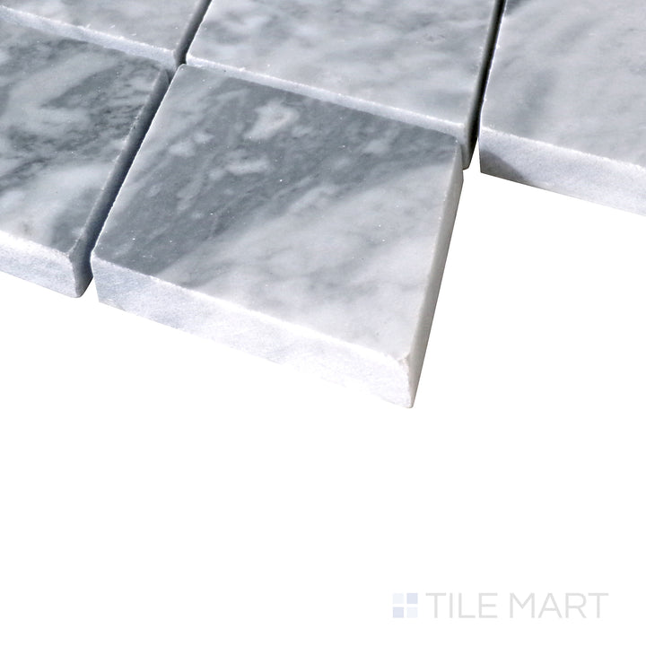 Slanted shot of Sto-Re Bardiglio Rhomboid polished marble mosaic, featuring deep gray hues, a striking rhomboid arrangement, and smooth polished texture.  