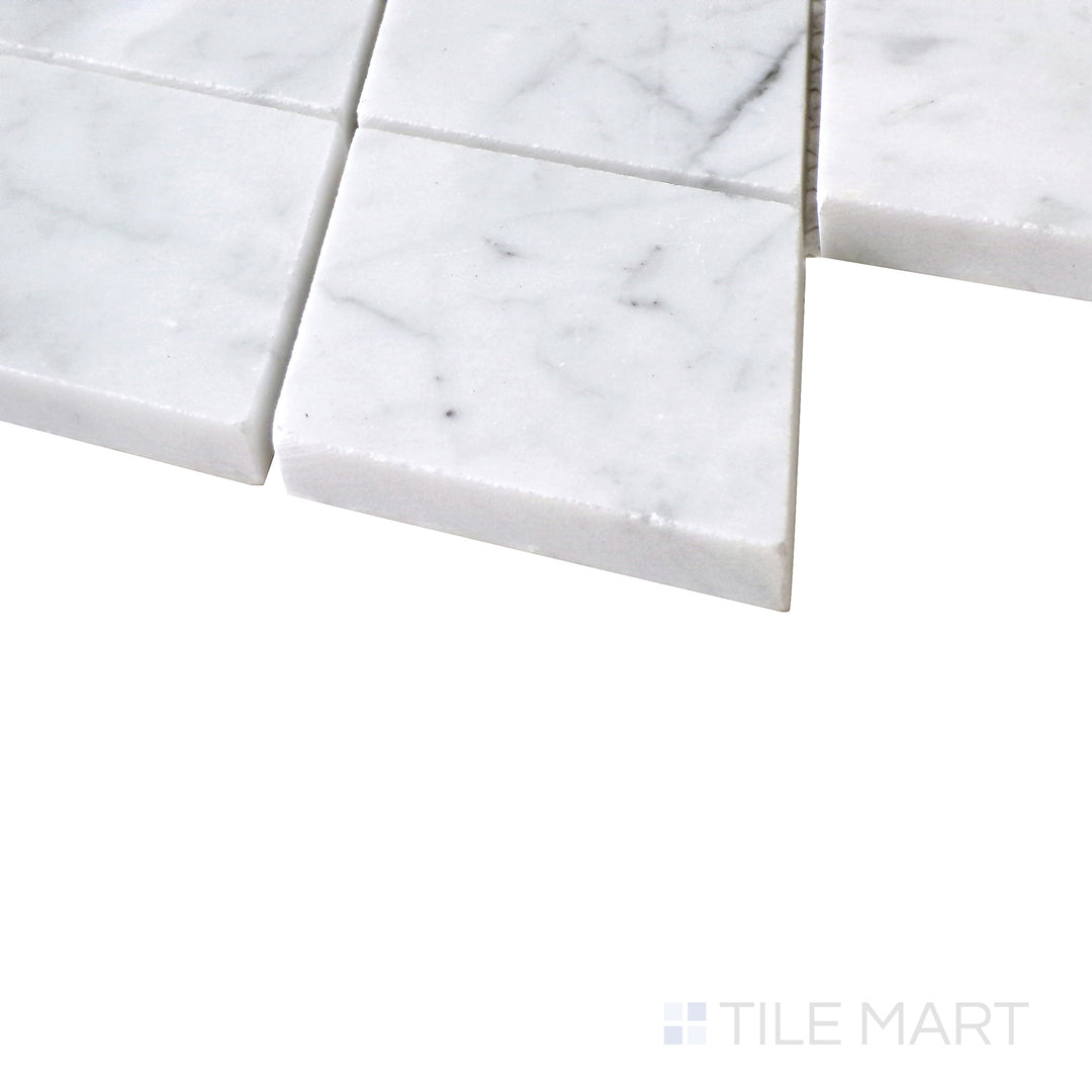 Diagonal angle of Sto-Re Carrara Rhomboid polished marble mosaic, showcasing its classic white marble, subtle gray veining, and dynamic rhomboid pattern.  