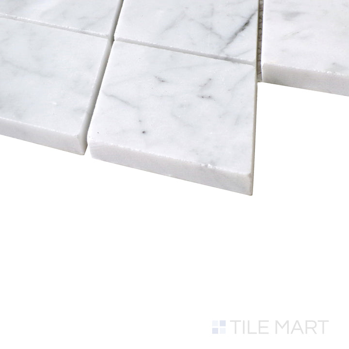 Diagonal angle of Sto-Re Carrara Rhomboid polished marble mosaic, showcasing its classic white marble, subtle gray veining, and dynamic rhomboid pattern.  