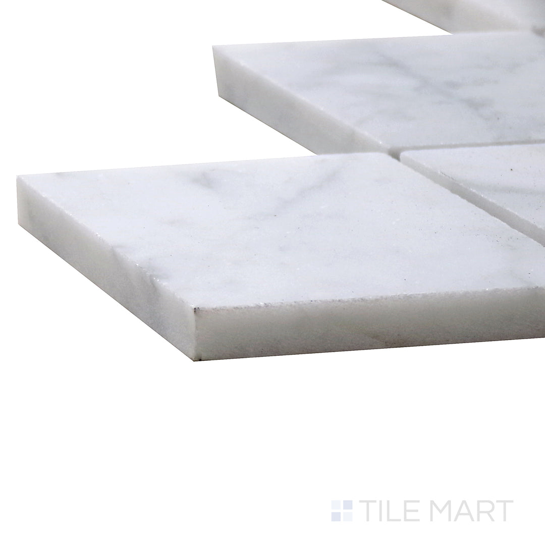 Angled view of Sto-Re Carrara Rhomboid Polished Marble Mosaic, capturing its clean white surface with elegant gray veining in a geometric rhomboid layout.