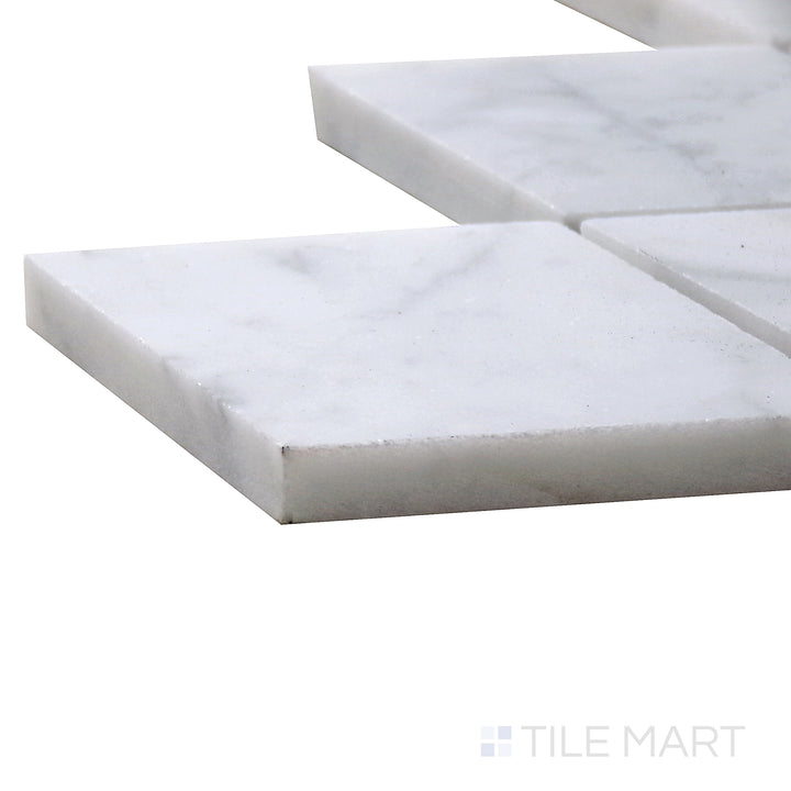 Angled view of Sto-Re Carrara Rhomboid Polished Marble Mosaic, capturing its clean white surface with elegant gray veining in a geometric rhomboid layout.