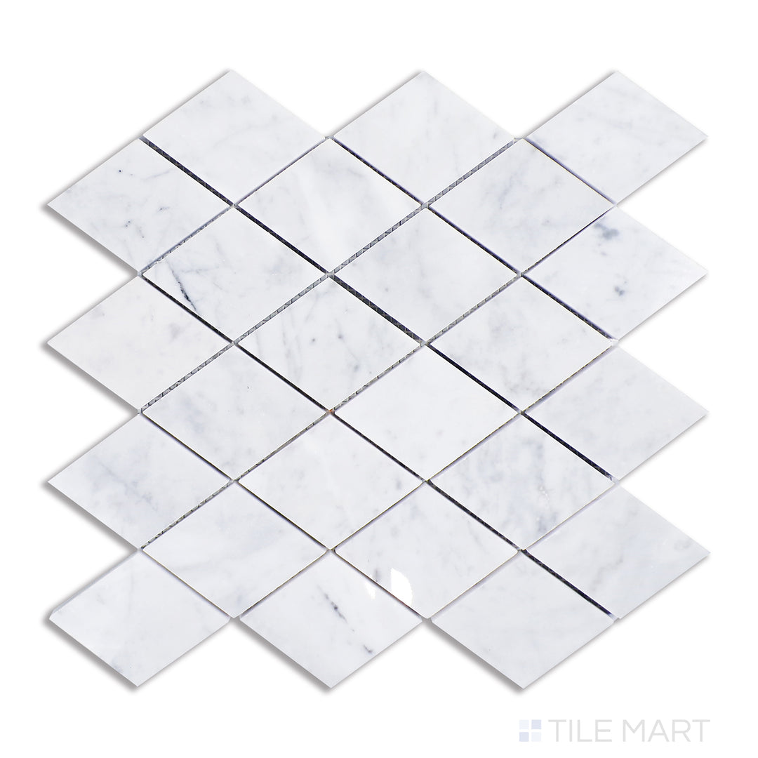 A detailed top-view of Carrara marble shaped into a geometric rhomboid design, highlighting a classic white base with delicate gray striations and a brilliant polished surface.