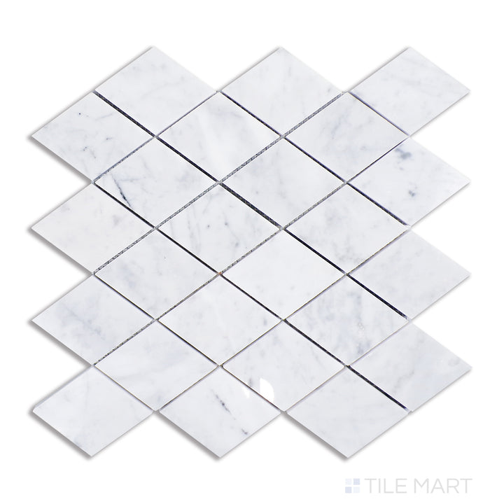 A detailed top-view of Carrara marble shaped into a geometric rhomboid design, highlighting a classic white base with delicate gray striations and a brilliant polished surface.