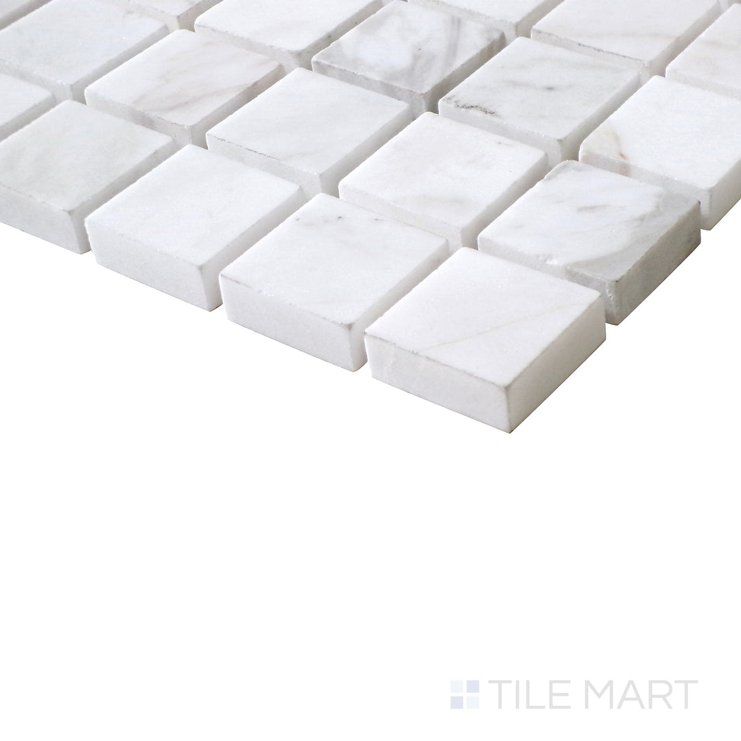 Diagonal view of Sto-Re Volakas 1-1/8" Square polished marble mosaic, capturing its soft veining, symmetrical square pattern, and glossy surface.  