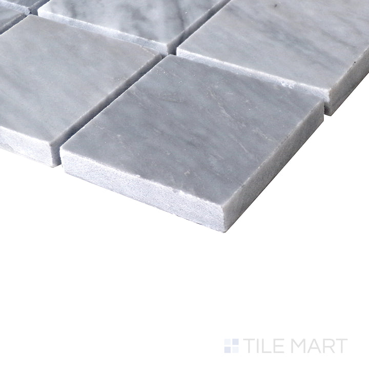 Angled shot of Sto-Re Bardiglio 2.25" Square polished marble mosaic, highlighting its bold gray shades, larger square format, and smooth polished surface.  