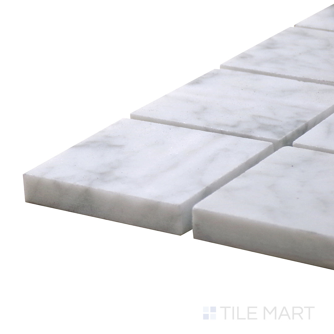 Angled view of Sto-Re Carrara 2.25" Square Polished Marble Mosaic, featuring soft white marble with natural gray veining in a square design.