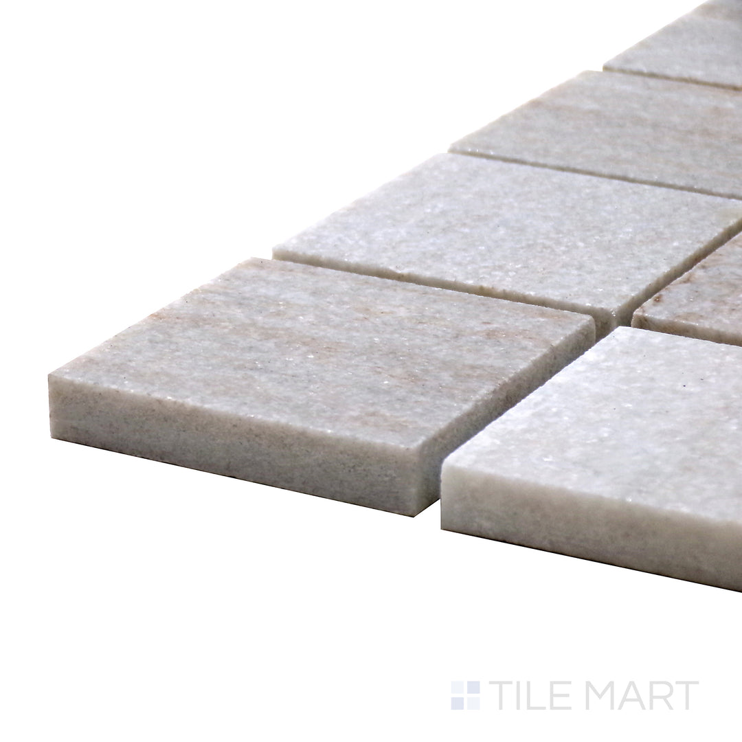Close-up side shot of Sto-Re Ocean White 2.25" Square Polished Marble Mosaic, showcasing its elegant white marble with a glossy finish.