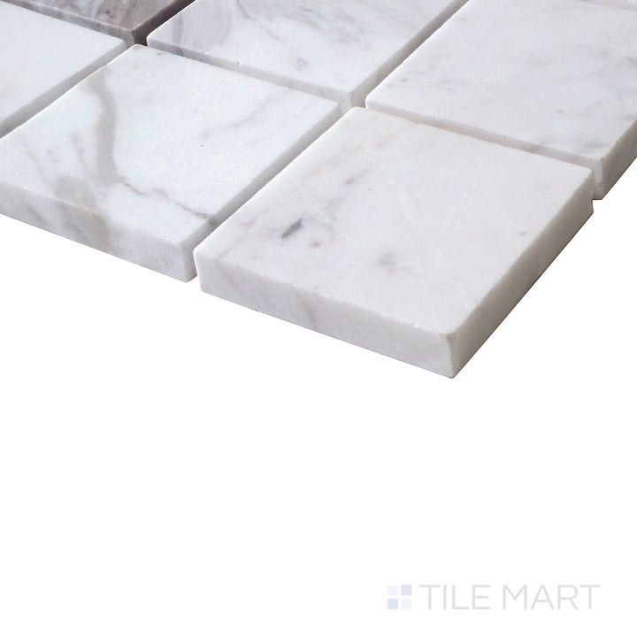 Angled shot of Sto-Re Volakas 2.25" Square polished marble mosaic, featuring refined veining, a symmetrical square pattern, and polished appeal.  