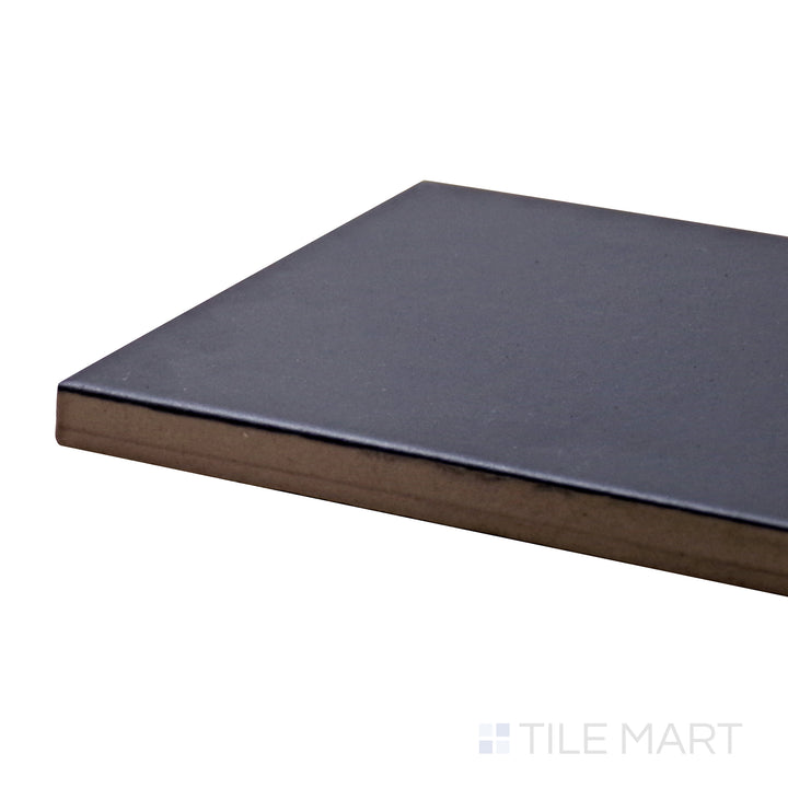 Angled view of Stromboli Black City 3.5X14.5 Matte Porcelain Tile, featuring its deep black hue with an urban-inspired matte texture.