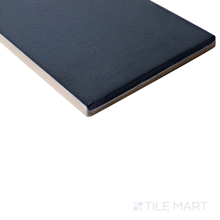 Angled shot of Stromboli Glassy Blue 3.5x14.5 matte porcelain tile, highlighting its rich blue tones, contemporary matte finish, and long rectangular shape.  