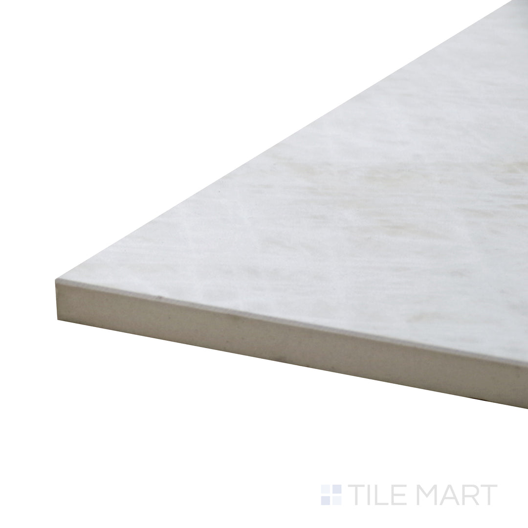 Angled view of Tele Di Marmo Reloaded Quarzo 12X24 Matte Porcelain Tile, showcasing its soft quartz-inspired white surface with subtle veining.