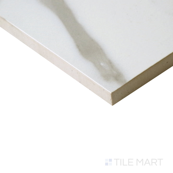 Angled shot of Tele Di Marmo Reloaded Calacatta 24x48 matte porcelain tile, highlighting its expansive format, crisp white base, and delicate veining with a smooth matte finish.  