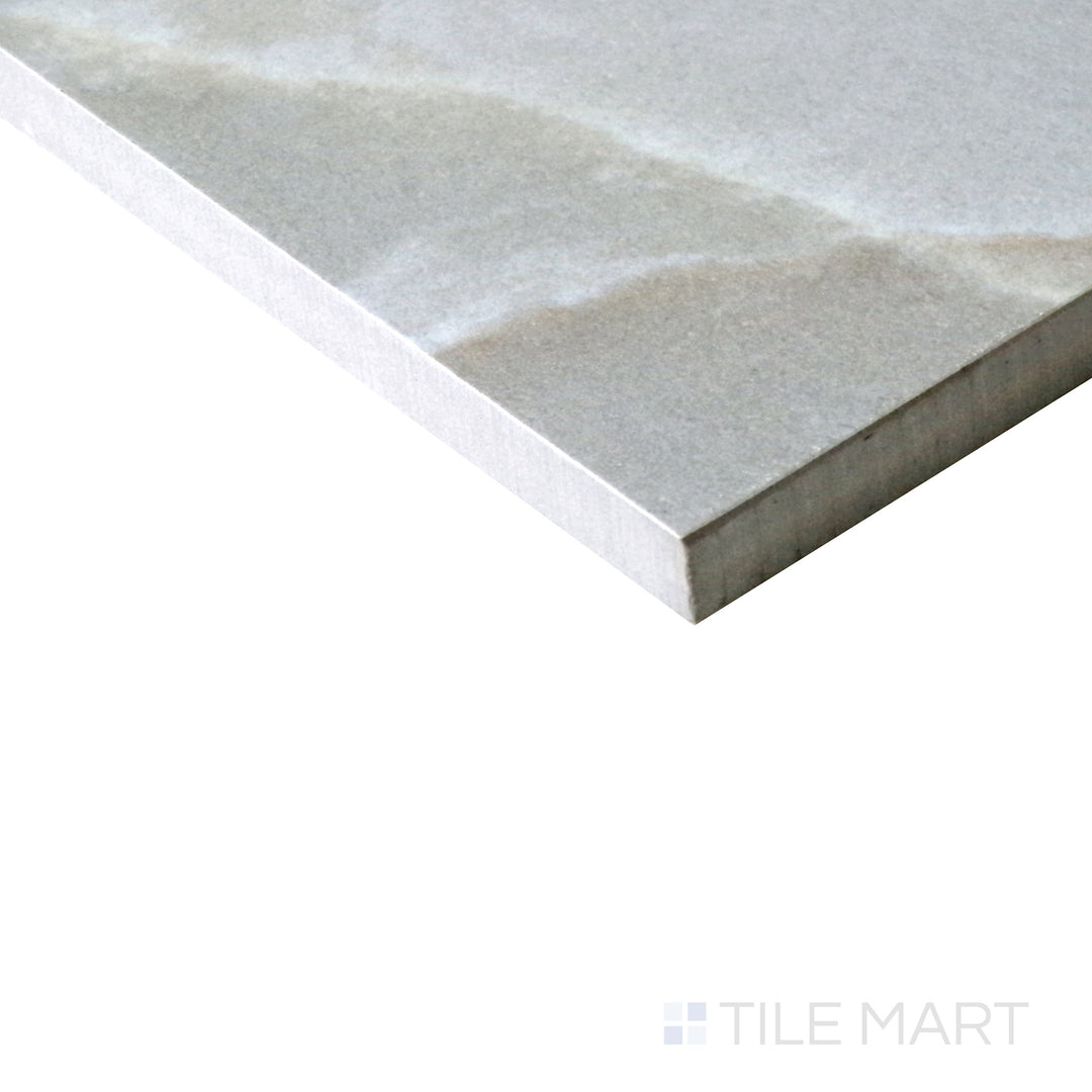 Slanted perspective of Tele Di Marmo Reloaded Onice Klmt 24x48 matte porcelain tile, emphasizing its translucent onyx appearance, luxurious veining, and smooth matte finish.  