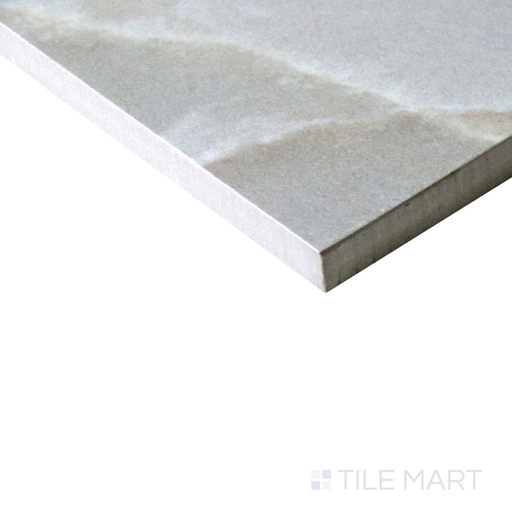 Slanted perspective of Tele Di Marmo Reloaded Onice Klmt 24x48 matte porcelain tile, emphasizing its translucent onyx appearance, luxurious veining, and smooth matte finish.  