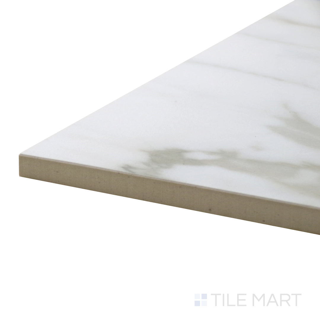 Close-up corner shot of Tele Di Marmo Reloaded Calacatta 12X24 Polished Porcelain Tile, capturing its glossy finish and rich gray veining on a pristine white background.