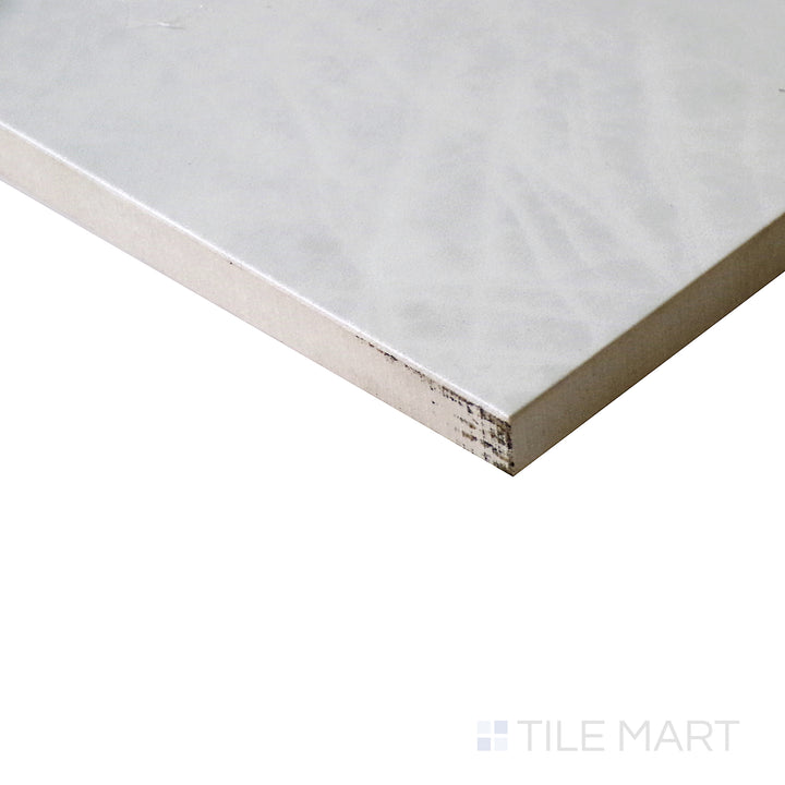 Slanted perspective of Tele Di Marmo Reloaded Quarzo 12x24 polished porcelain tile, featuring a refined quartz-like appearance, polished sheen, and soft natural tones.  