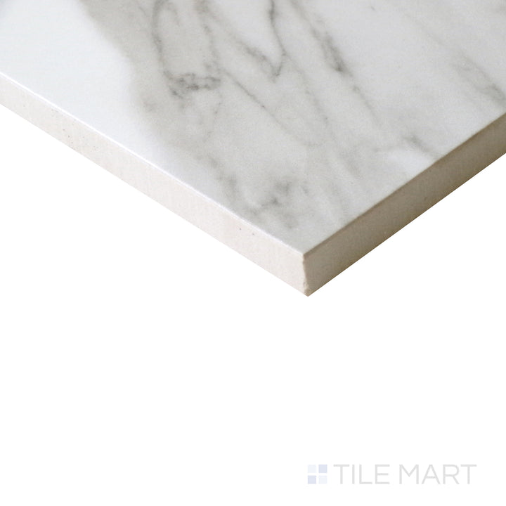 Angled view of Tele Di Marmo Reloaded Calacatta 24x48 polished porcelain tile, showcasing its elegant white base, dramatic gray veining, and reflective polished surface.  