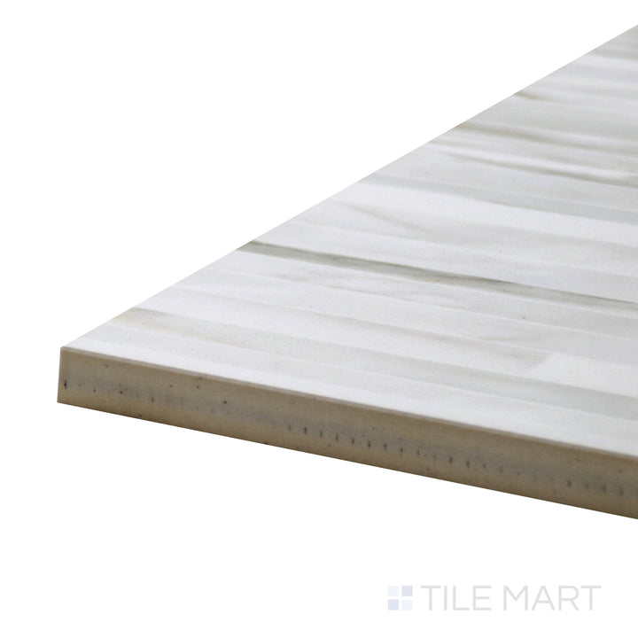 Angled close-up of Tele Di Marmo Reloaded Calacatta 24X48 Polished Porcelain Tile, capturing its polished marble look with bold gray veining and a luminous finish.