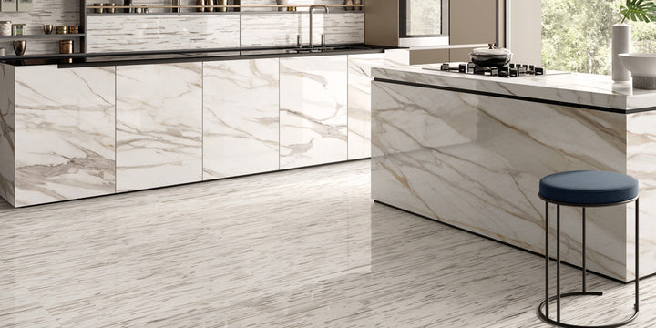 A luxurious interior designed with Tele Di Marmo Reloaded Calacatta 24X48 Polished Porcelain, showcasing brilliant white marble tones with delicate veining in a high-gloss finish.