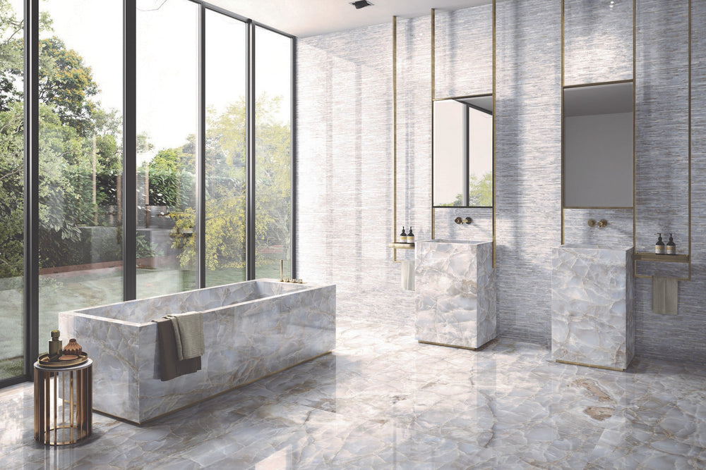 A dramatic yet sophisticated setting accentuated by Tele Di Marmo Reloaded Onice Klmt 24X48 Polished Porcelain, embodying deep onyx details with an ultra-glossy effect.
