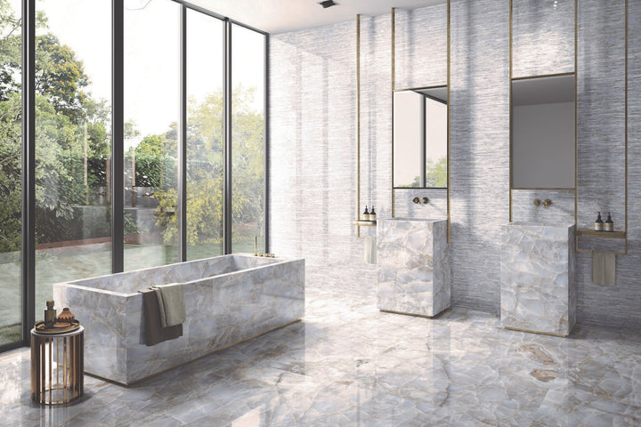 A dramatic yet sophisticated setting accentuated by Tele Di Marmo Reloaded Onice Klmt 24X48 Polished Porcelain, embodying deep onyx details with an ultra-glossy effect.