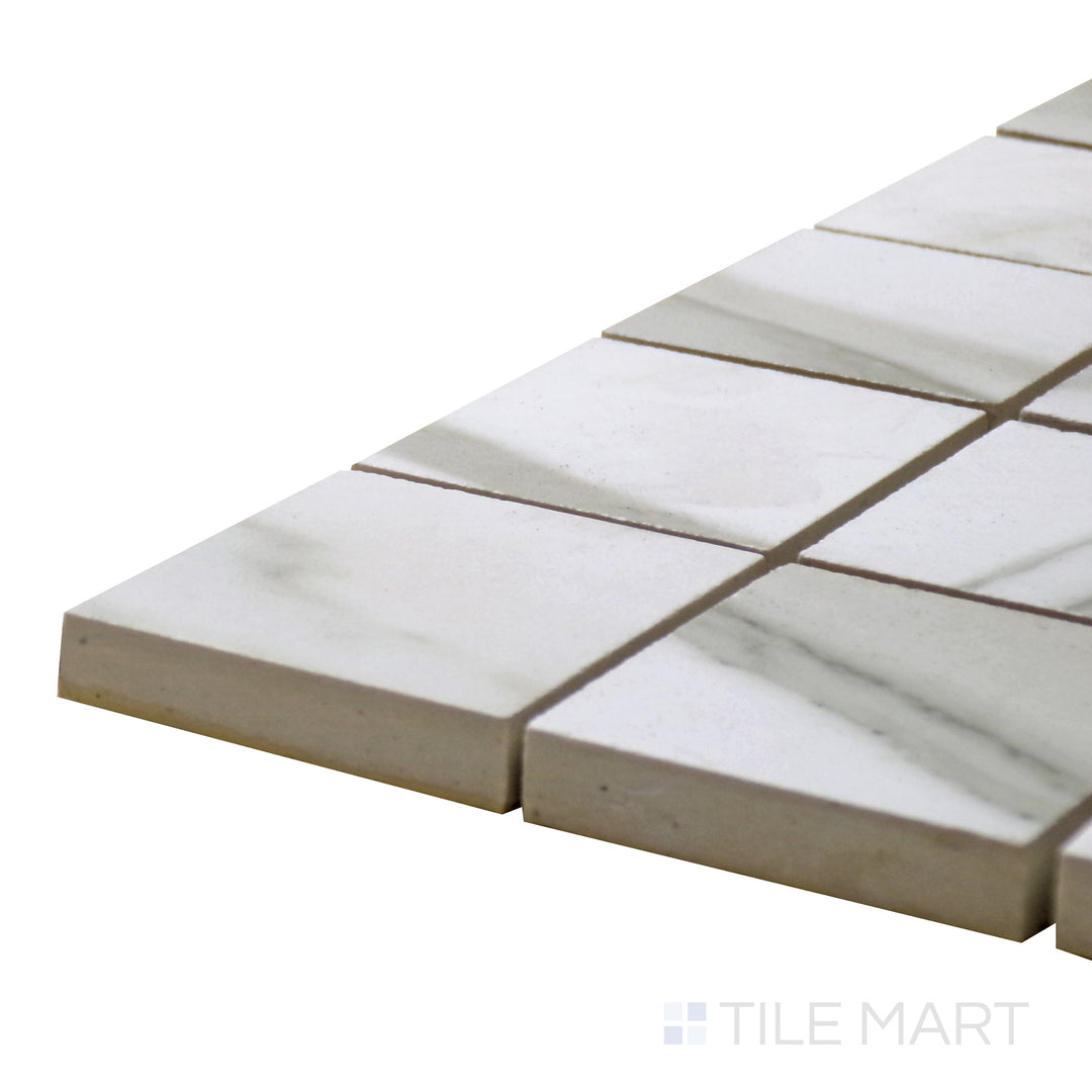 Close-up corner shot of Tele Di Marmo Reloaded Calacatta 2" Square Matte Porcelain Mosaic, featuring crisp white marble with striking gray veining in a refined square format.
