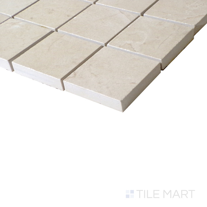 Slanted perspective of Tele Di Marmo Reloaded Marfil 2" Square matte porcelain mosaic, emphasizing its warm beige tones, soft veining, and geometric square arrangement.  