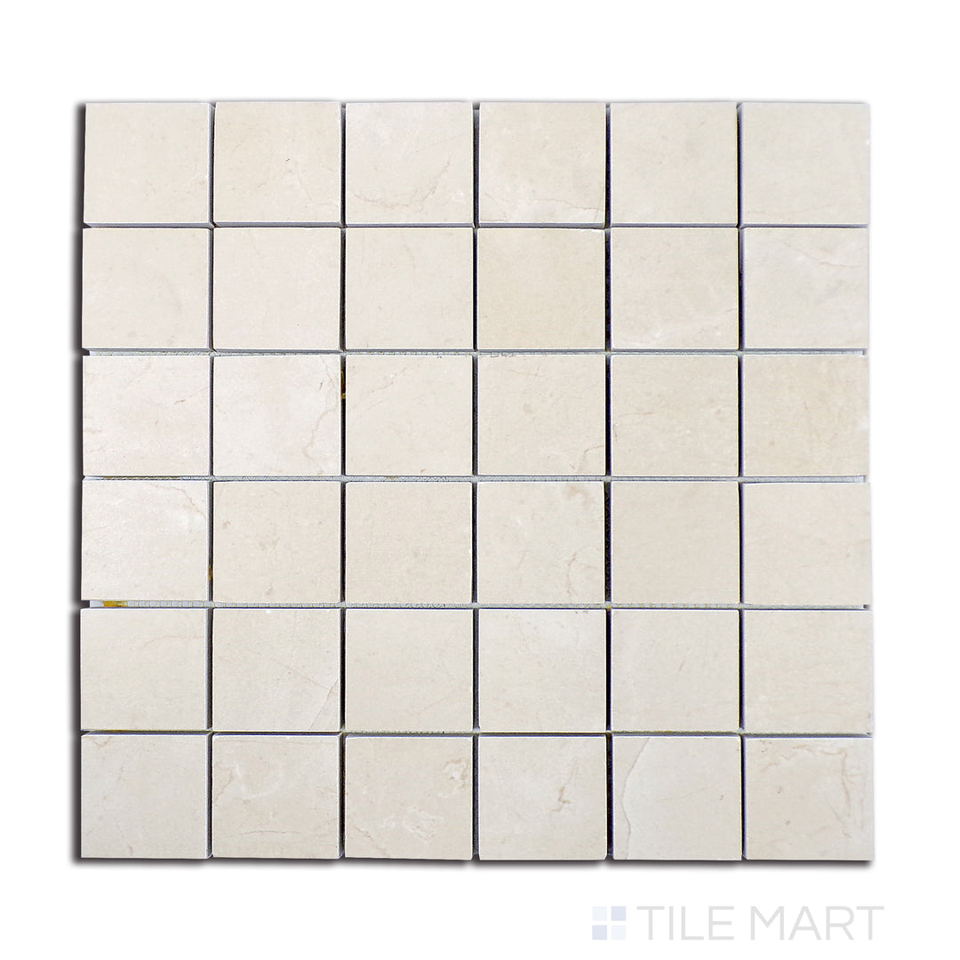 Overhead shot of Tele Di Marmo Reloaded Marfil 2" square matte porcelain mosaic, presenting a warm beige stone look with soft, natural patterns.