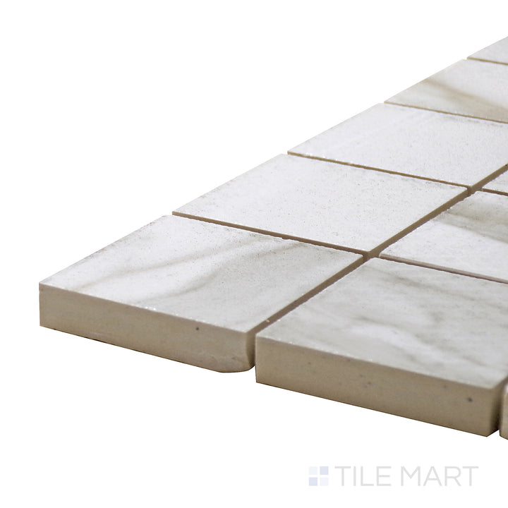 Corner-focused shot of Tele Di Marmo Reloaded Calacatta 2" Square Polished Porcelain Mosaic, featuring its elegant marble design with high-gloss veining.