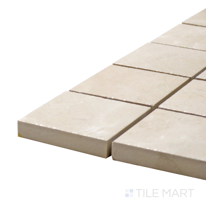 Close-up corner shot of Tele Di Marmo Reloaded Marfil 2" Square Polished Porcelain Mosaic, displaying its rich beige marble tones with a polished, reflective finish.