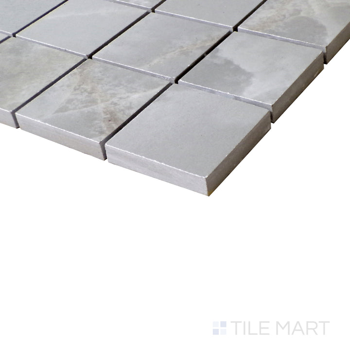 Slanted angle of Tele Di Marmo Reloaded Onice Klmt 2" Square polished porcelain mosaic, showcasing its bold onyx-inspired patterns, smooth finish, and polished sheen.  