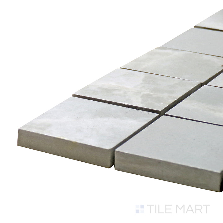 Side perspective of Tele Di Marmo Reloaded Onice Klmt 2" Square Polished Porcelain Mosaic, capturing its warm, translucent onyx tones with a high-shine polish.