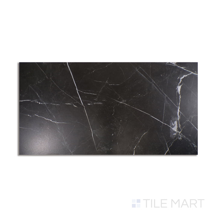 Top-down view of Tele Di Marmo Revolution Calacatta Black 24X48 matte porcelain, a striking black and white marble look with bold veining.