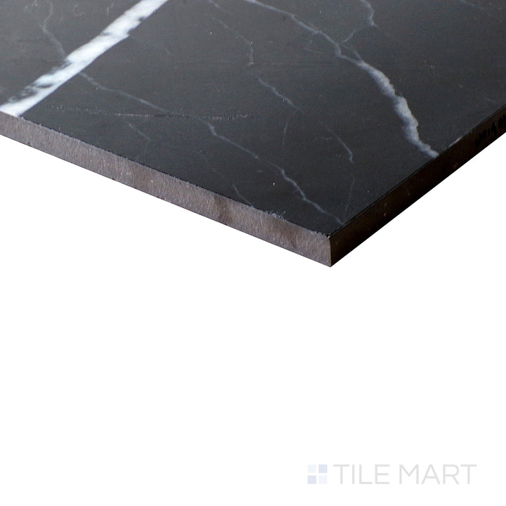Diagonal shot of Tele Di Marmo Revolution Calacatta Black 24x48 polished porcelain tile, featuring dramatic black veining, crisp white background, and a glossy polished surface.  
