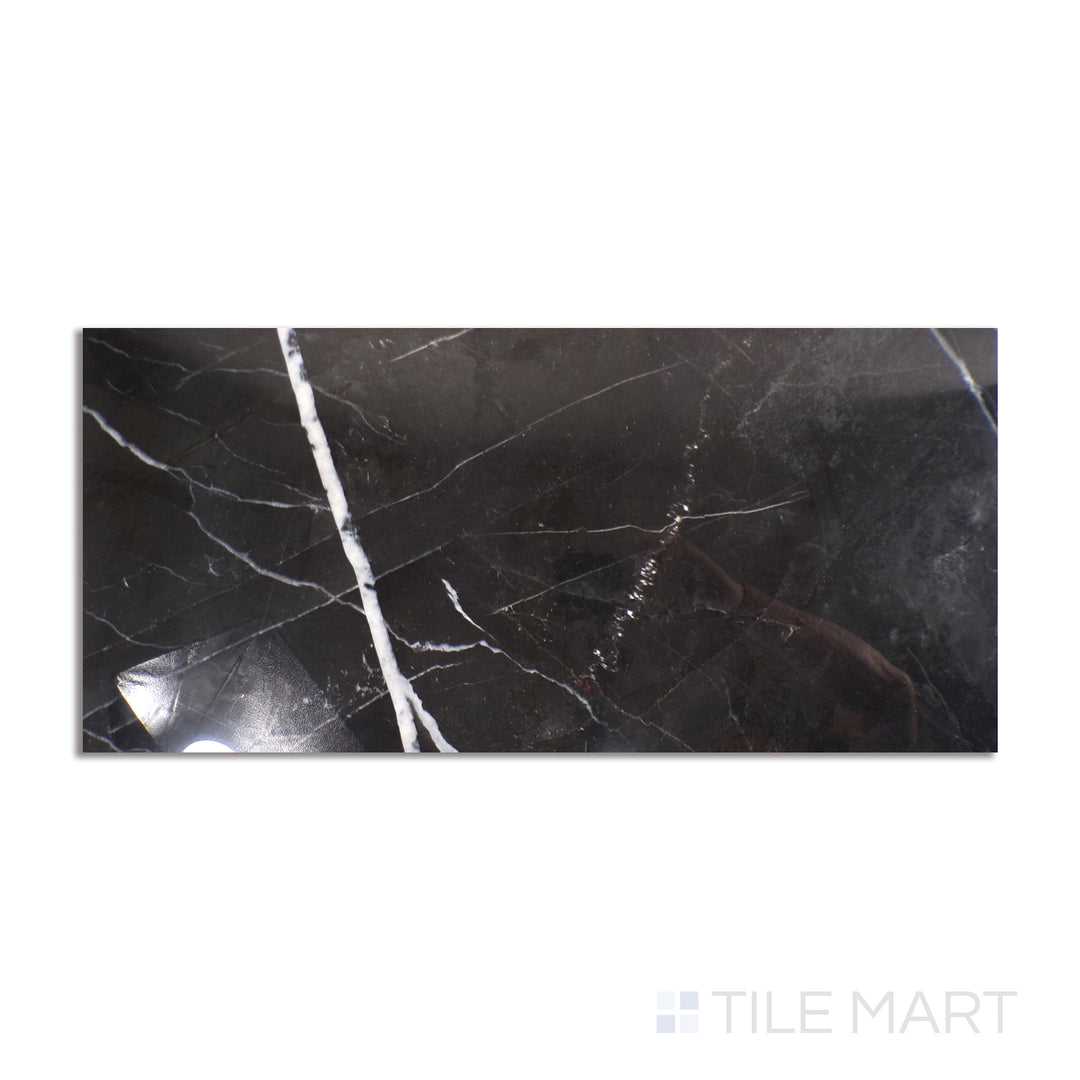 Top-down view of Tele Di Marmo Revolution Calacatta Black 24X48 polished porcelain, an ultra-glossy surface with contrasting black and white marble patterns.