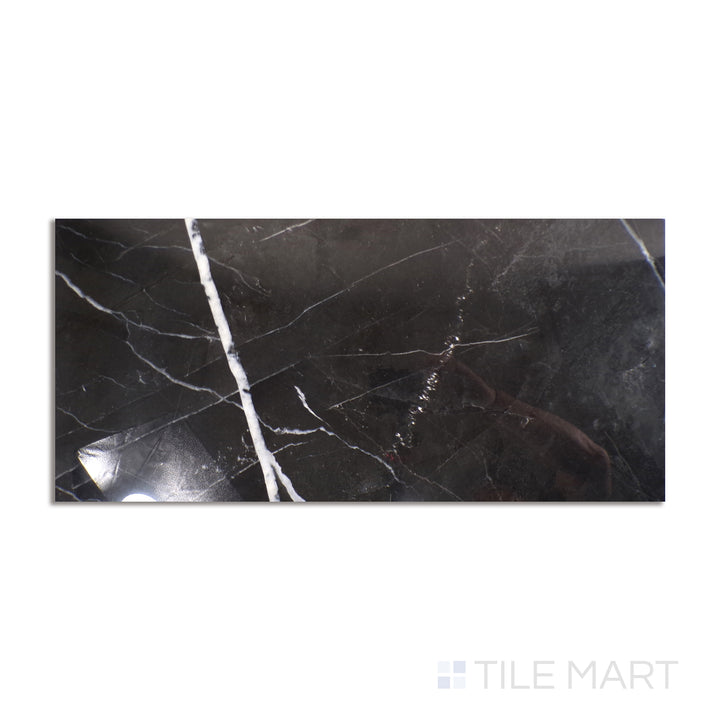 Top-down view of Tele Di Marmo Revolution Calacatta Black 24X48 polished porcelain, an ultra-glossy surface with contrasting black and white marble patterns.