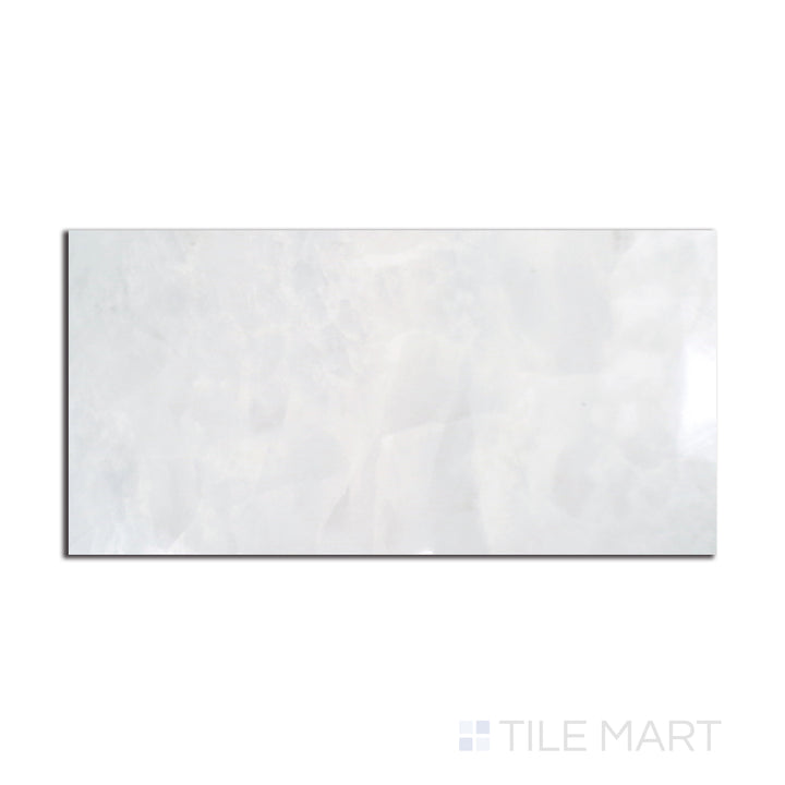 Flat-lay image of Tele Di Marmo Revolution Thassos 24X48 polished porcelain, a brilliant white tile with a radiant polished glow.